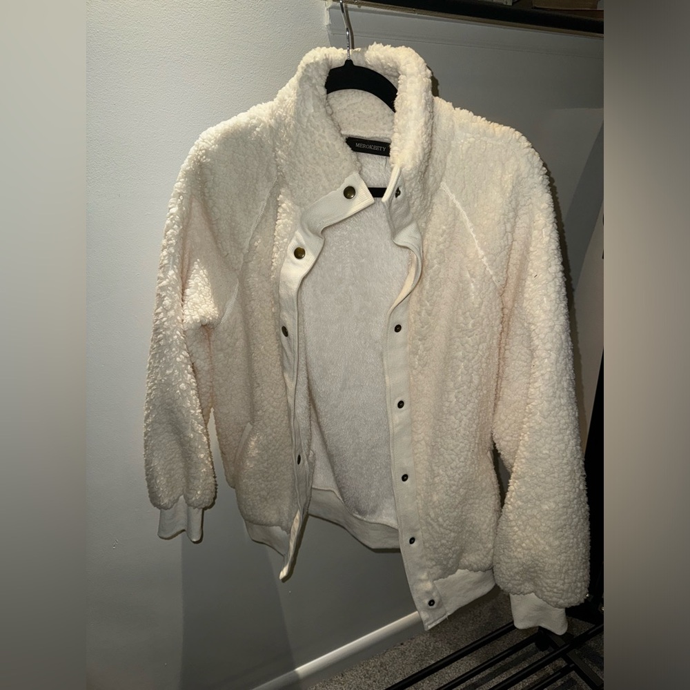 Brand new, never worn. Fluffy cream button up jacket